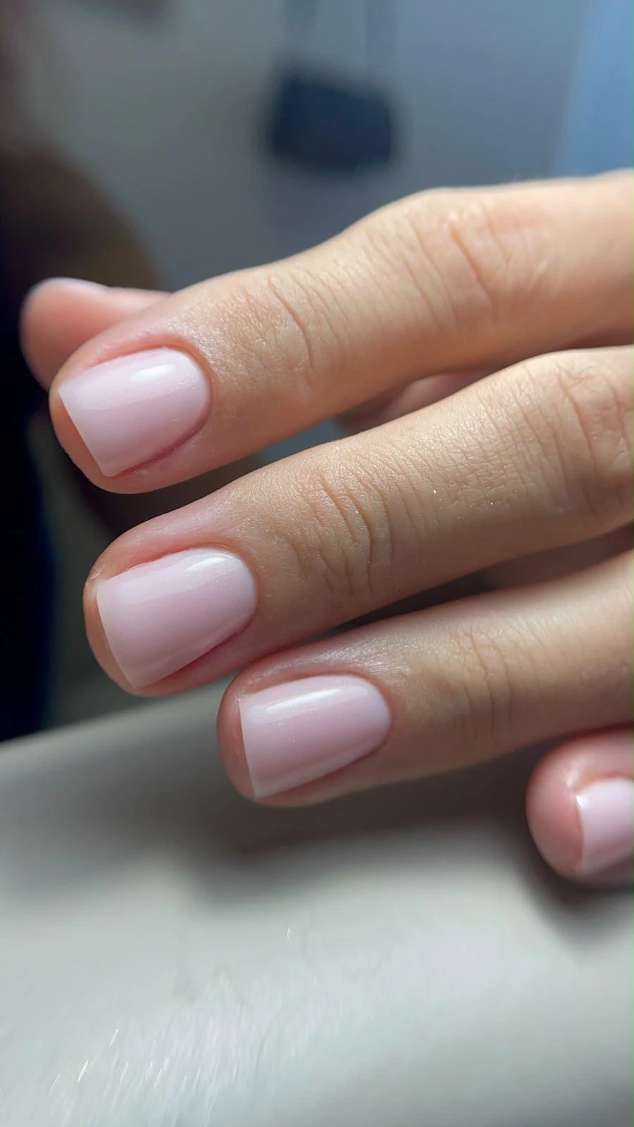 Verniz de gel rosa claro em unhas curtas quadradas